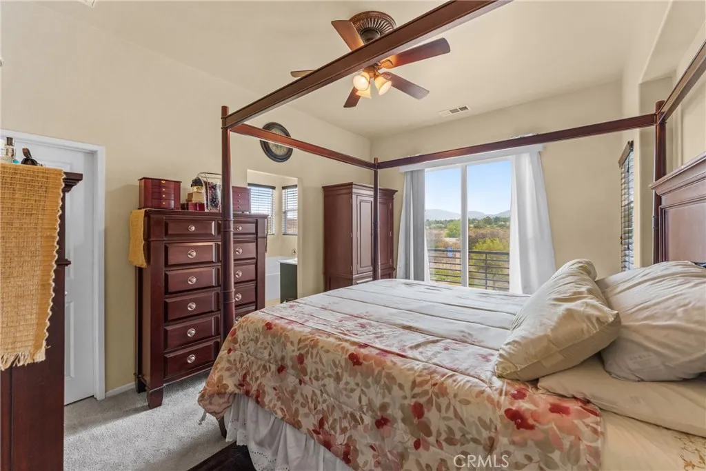 Spacious primary bedroom featuring a private balcony, a large walk-in closet, and primary bathroom.