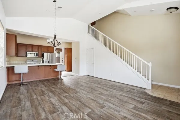 Stairs next to living room and dining area.