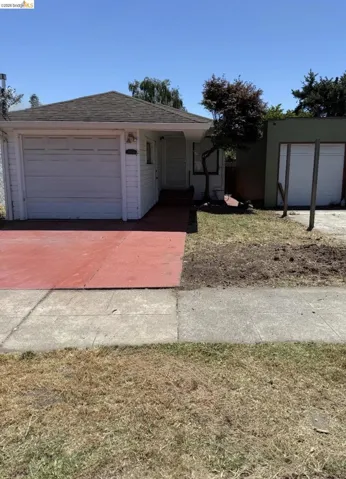 White siding exterior featuring a single-car garage with a white door