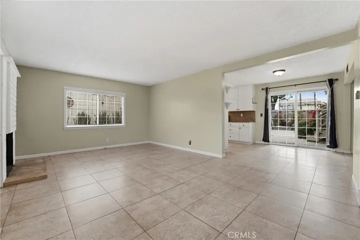 Living Room with fireplace, open floor plan, windows, spacious with lots of light