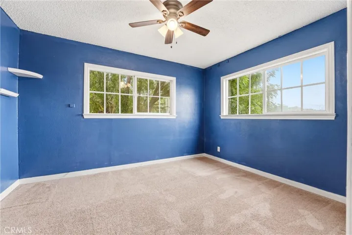 Naturally lit bedroom with a reliable fan