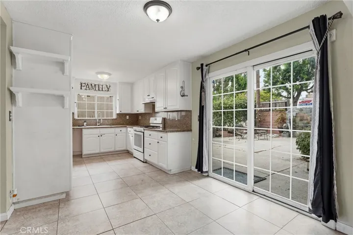 Open and bright kitchen with sliding door to backyard