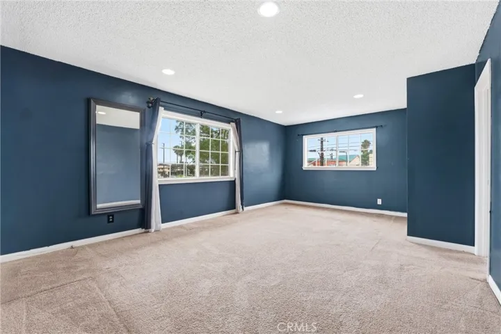 Large bonus room with recessed lighting with windows, loft, or bedroom with closet and enclosed room inside with slide door closet and window. This space has many possibilities depending on your preferences and needs.
