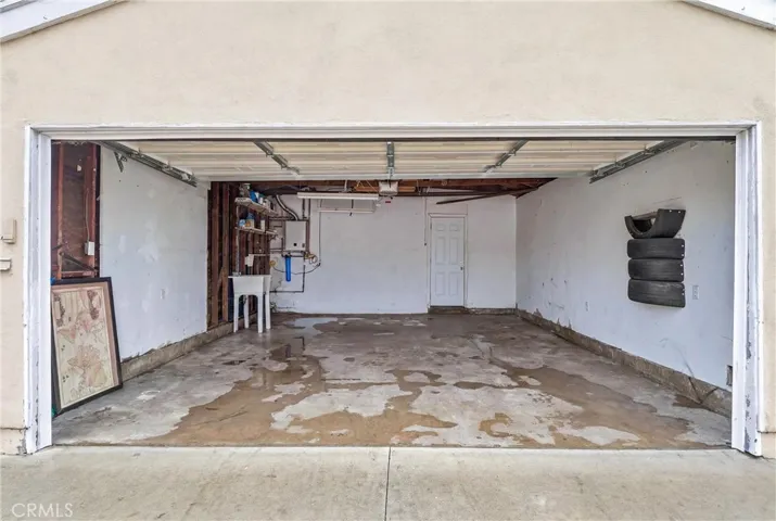 Spacious garage with door entrance from backyard