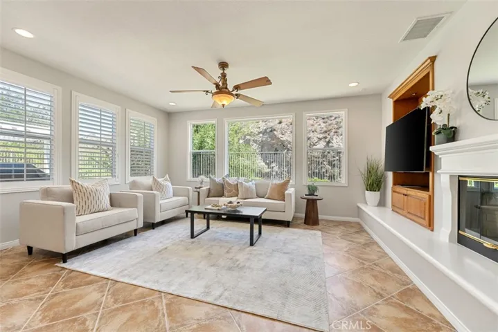 Great room has fireplace, recessed lights, built-in entertainment cabinet
