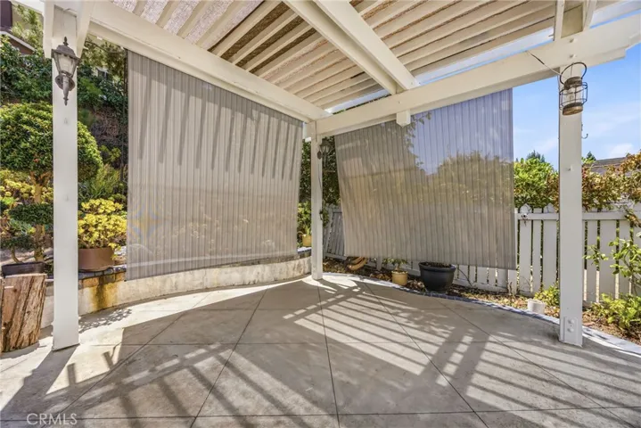 Charming pergola area equipped with protective shades for private outdoor relaxation