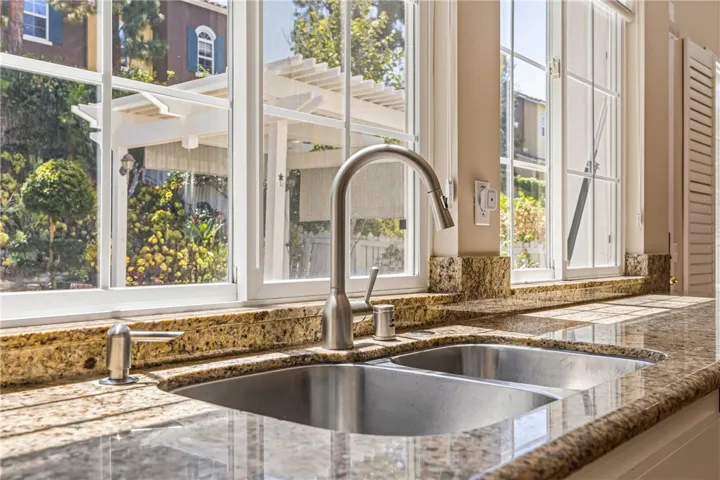 Kitchen sink window offering a beautiful and peaceful view of the backyard