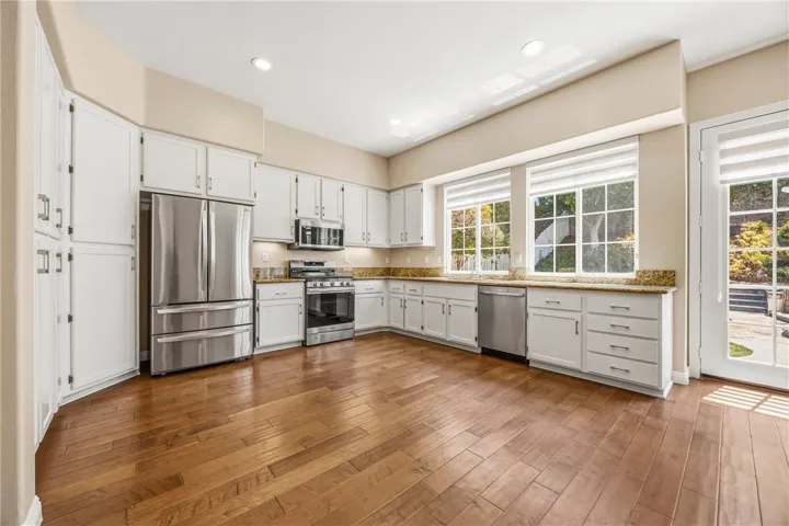 Fully remodeled kitchen with sleek Samsung & LG stainless steel appliances and white cabinetry