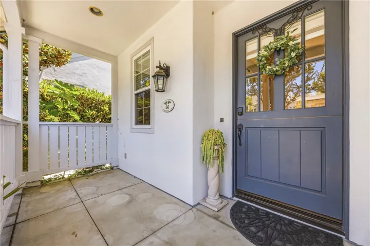Welcoming and charming front entrance with a cozy porch area