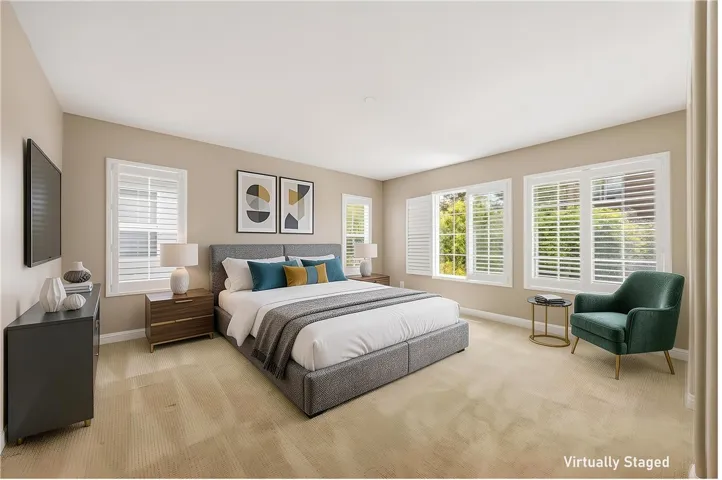 Spacious master bedroom with abundant natural light and elegant shutters (Virtually Staged)