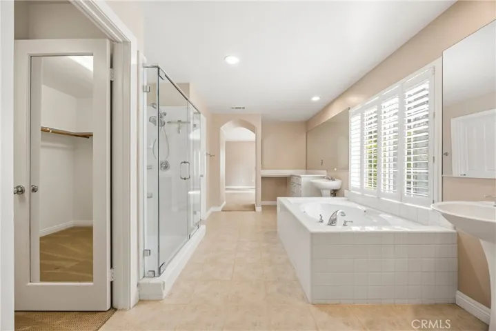 Another view of the master bath showcasing the spacious walk-in closet and seamless layout