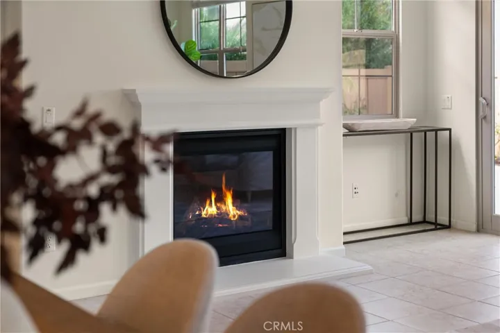 Fireplace feature with traditional mantel creating a warm focal point for the living space.