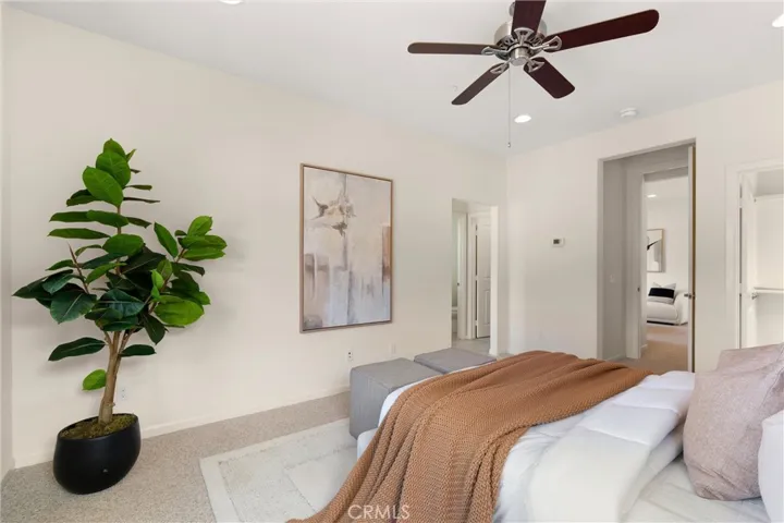 Comfortable primary suite designed with an open layout, abundant natural light, and a calm neutral palette.
