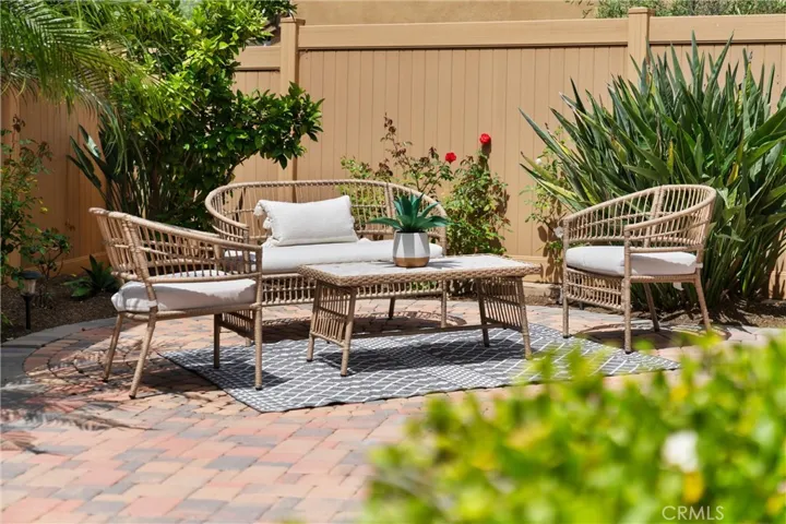Outdoor patio area featuring paver hardscape and space for outdoor dining, relaxing, or gathering.