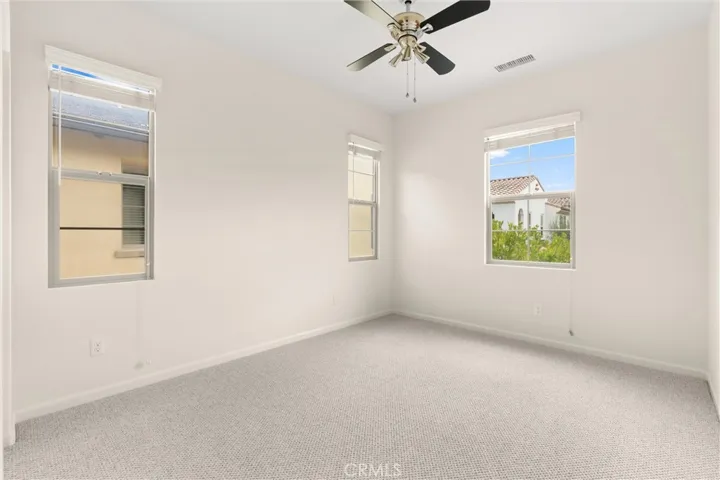 Bright secondary bedroom with an open layout and versatile functionality.
