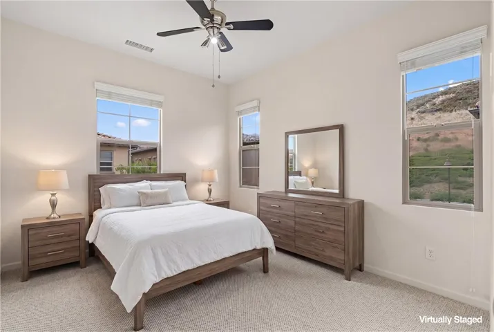 Spacious secondary bedroom featuring recessed lighting, large windows, and soft natural light. VIRTUALLY STAGED