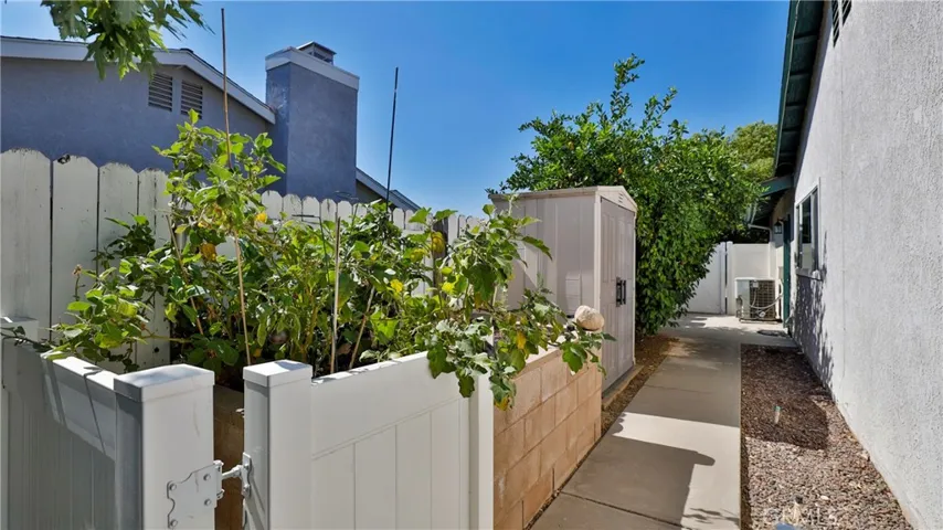 West side of the home has an above ground planter area for more gardening opportunities. The shed stays.