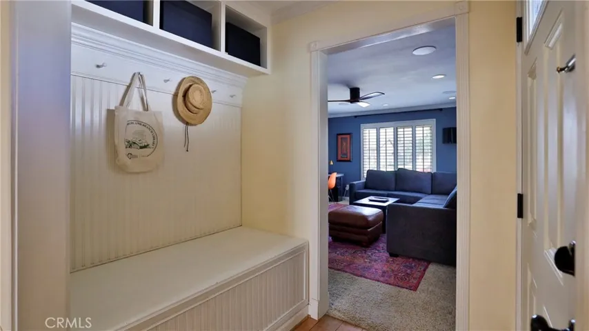As you step into this beautiful home you will see a built in seating bench and pegs to hang your hat, backpack etc. It also has cubby areas above. The family room is just beyond the entryway.