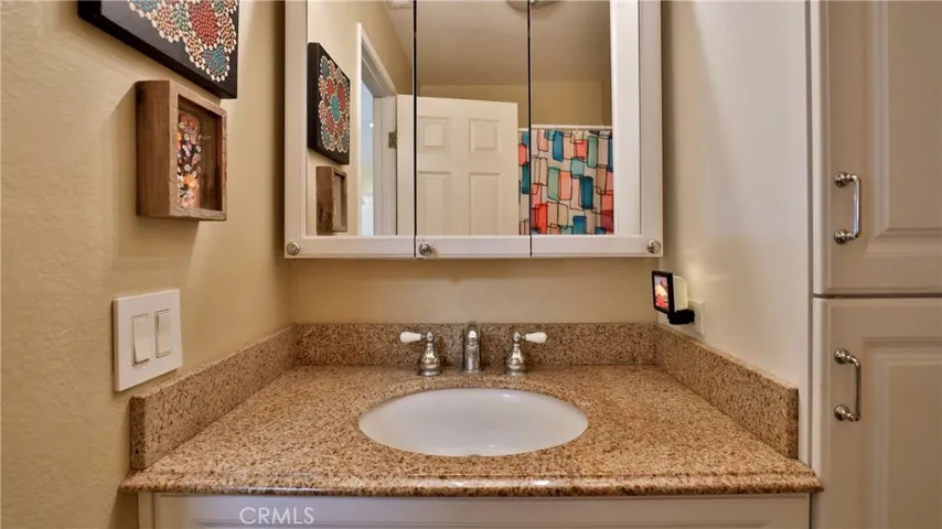 Hall bath, vanity, medicine cabinets, shower/tub combo