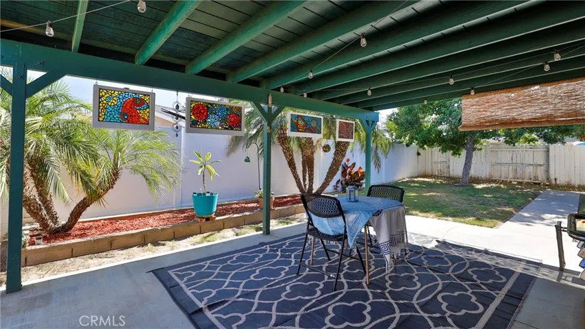 Check out this backyard retreat! Large covered patio with roll down sun shades