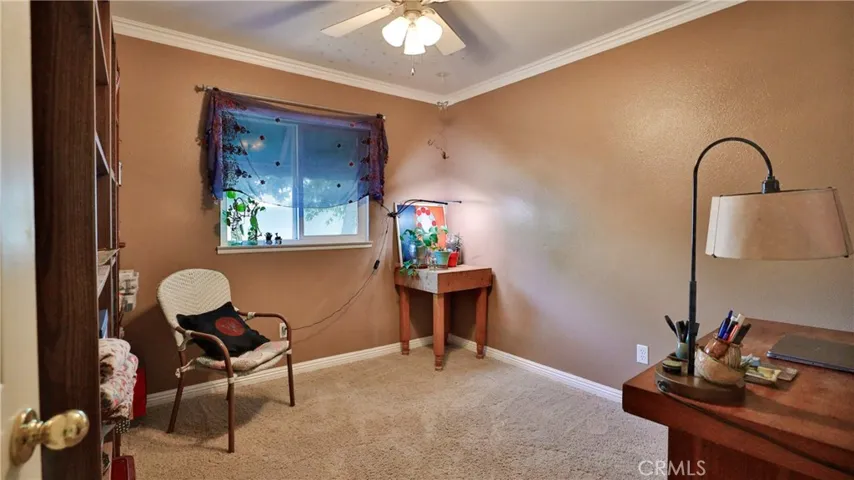 Bedroom #2 features: carpet, ceiling fan, crown molding