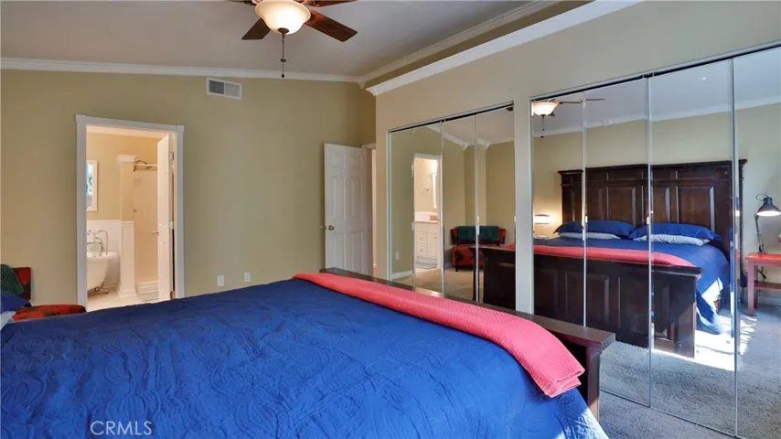 Primary bedroom has large mirrored closets for tons of storage