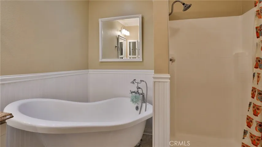 Primary bathroom: claw tub, walk in shower