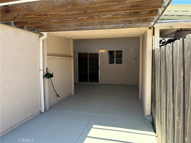 Open beam cover at the yard side of the patio meets the ample enclosed area going into the home and garage  patio doors.