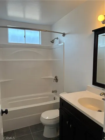 Bath has tile floors, tub shower and is clean as a whistle.