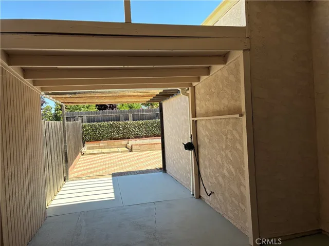 Wonderful, extra long patio is covered over the half the enters the home and open beam on the yard side.