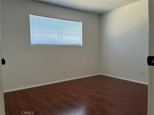 Guest room has a nice big window to let in morning sun and light, pretty wood flooring and big closet.