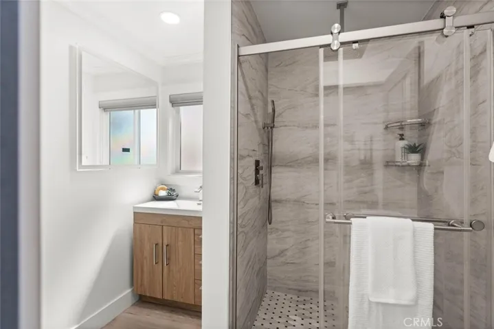 Beautifully tiled walk-in shower with dual shower heads.
