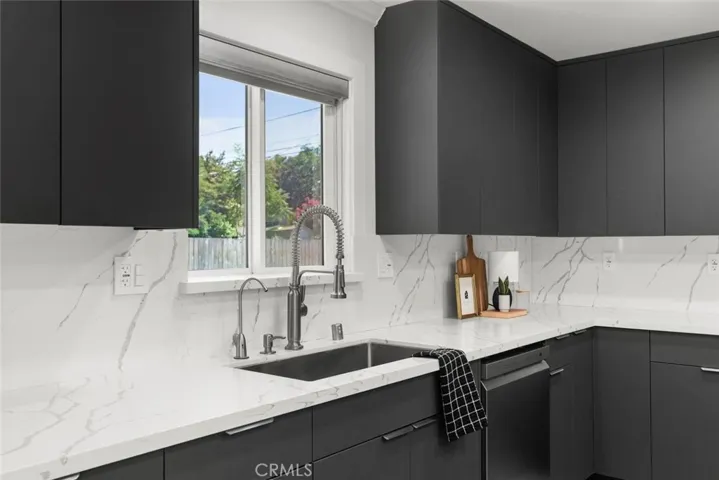 Quartz countertop and slab backsplash.