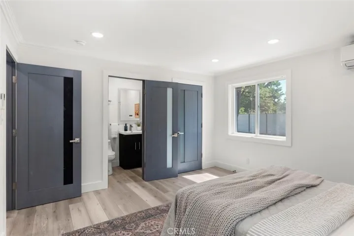 Ensuite bathroom with walk-in closet with built-ins.