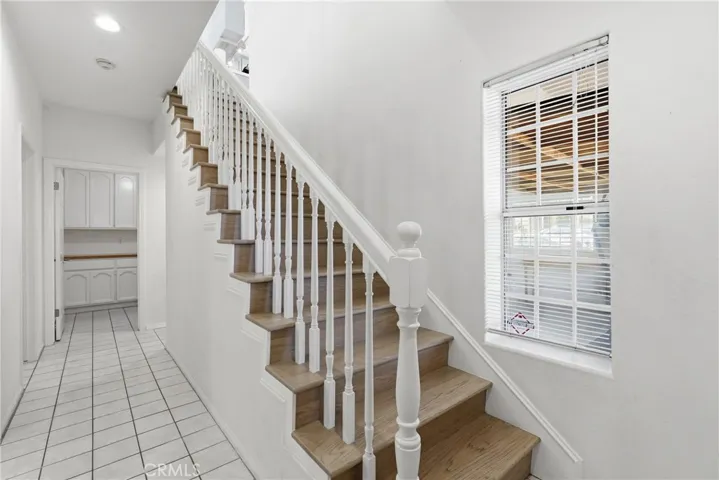 Stairs and downstairs hallway with laundry room in back