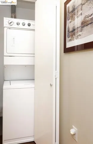 Laundry room featuring stacked washer / drying machine