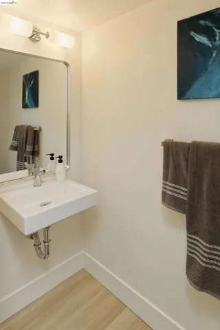 Bathroom featuring light wood-style floors and baseboards