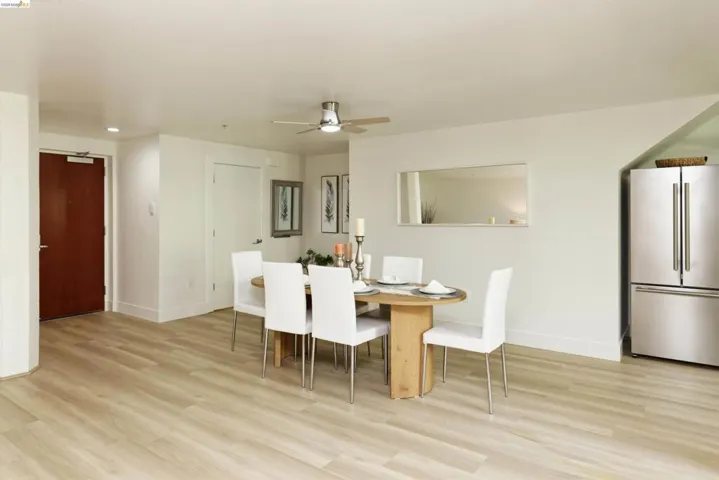 Dining area with light wood-style flooring, a ceiling fan, and recessed lighting