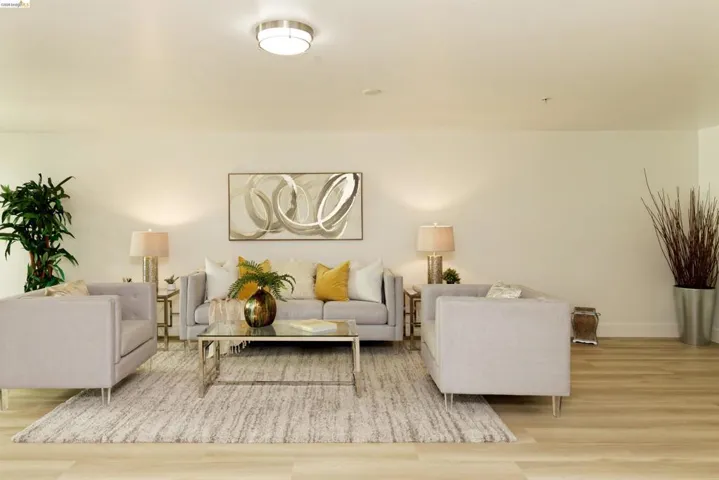 Living area with wood finished floors and baseboards
