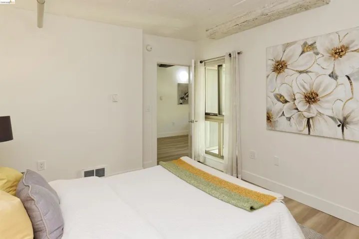 Bedroom with wood finished floors and baseboards