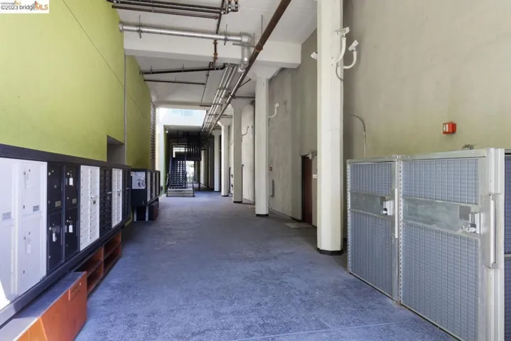 Corridor featuring a towering ceiling and mail area