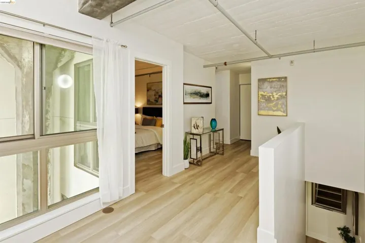 Hall with an upstairs landing and light wood finished floors