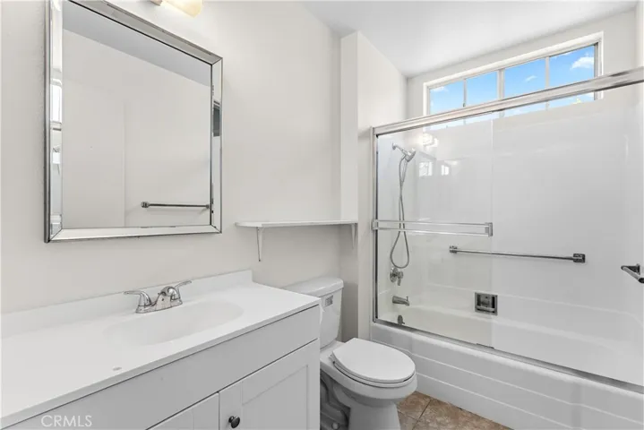 Common bathroom with newly installed shower enclosure