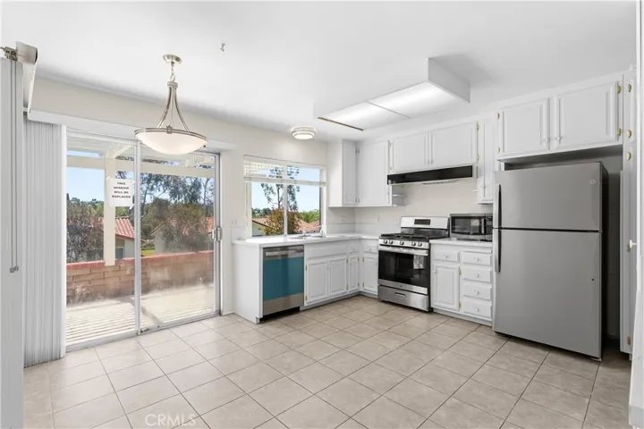 Kitchen with newly installed lighting fixture complete with new appliances :- Refrigerator, Dishwasher, Stove/Oven and microwave