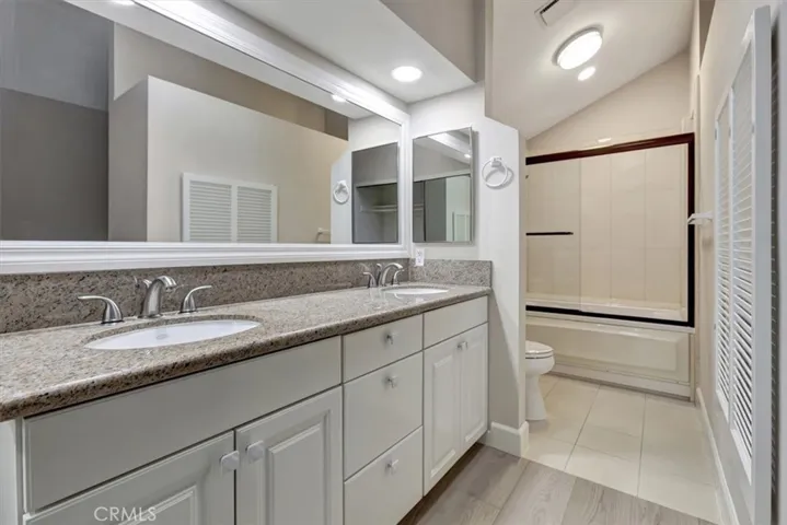 Dual lavs in primary bathroom dressing area, privacy door into commode and jetted tub with shower over tub and skylight PLUS light from the atrium into tub area - soothing, relaxing, tranquil!