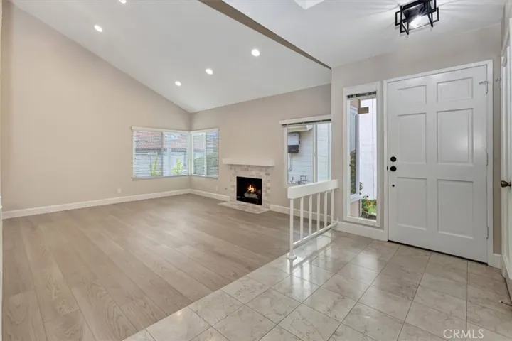 Marble entry - living room cathedral ceiling, recessed lighting, cozy gas fire fireplace. Newer paint, baseboards, luxury vinyl plank flooring
