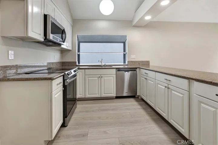 REFRIGERATOR IS INCLUDED - old photo - Kitchen - two globes and recessed lighting, freshly painted, new knobs, garden window, cathedral ceiling and bright skylight