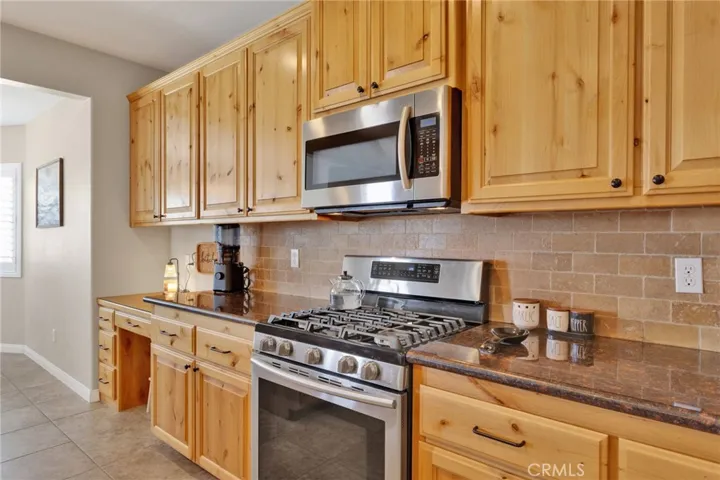 Upgraded appliances. Seated desk with custom glass top.