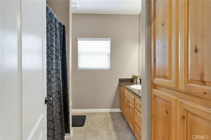 Hall bathroom with the same lovely cabinetry found throughout the home