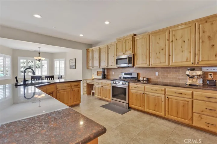 Large center island with sink is ideal for breakfast bar dining, and serving a buffet.